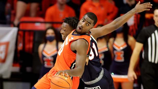 Nov 9, 2021; Champaign, Illinois, USA; Illinois Fighting Illini guard Da'Monte Williams (20) dribbles the ball around Jackson State Tigers forward Jamarcus Jones (31) in the second half at State Farm Center. Mandatory Credit: Ron Johnson-USA TODAY Sports